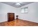 Bright bedroom with hardwood floors, ceiling fan, and a dresser with ample storage at 6365 S Valleyview St, Littleton, CO 80120