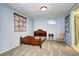 Charming bedroom with wooden bed frame, rocking chair, and blue painted walls at 6365 S Valleyview St, Littleton, CO 80120