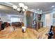 Open-concept dining area next to kitchen and living room, featuring a modern chandelier and stainless steel refrigerator at 6365 S Valleyview St, Littleton, CO 80120