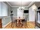 Cozy dining area with round table, a modern chandelier, and stylish accents, adjacent to the kitchen at 6365 S Valleyview St, Littleton, CO 80120