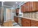 Traditional-style kitchen featuring wooden cabinets, granite countertops, and stainless steel appliances at 6365 S Valleyview St, Littleton, CO 80120