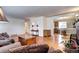 Open living space with hardwood floors that connect to dining area, featuring a brick fireplace and neutral wall paint at 6365 S Valleyview St, Littleton, CO 80120