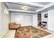 Basement living space with decorative rug, accent chair, and folding director's chair at 6365 S Valleyview St, Littleton, CO 80120
