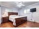 Comfortable bedroom with hardwood floors, a ceiling fan, and a large window for natural light at 6365 S Valleyview St, Littleton, CO 80120