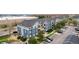 Scenic aerial view of an apartment building featuring manicured grounds, ample parking, and nearby retail at 4451 S Ammons St # 5-307, Littleton, CO 80123