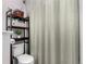 This bathroom features a toilet with a gray curtained shower, and a storage shelf at 4451 S Ammons St # 5-307, Littleton, CO 80123