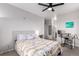 This bedroom features a ceiling fan, neutral walls, carpet flooring, and a desk area at 4451 S Ammons St # 5-307, Littleton, CO 80123