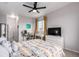 This bedroom features a ceiling fan, two windows with shades, a desk, and neutral-toned walls at 4451 S Ammons St # 5-307, Littleton, CO 80123