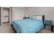 Cozy bedroom showcasing blue-painted furniture, and a blue, white, and yellow bed cover at 4451 S Ammons St # 5-307, Littleton, CO 80123