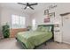 Cozy bedroom features natural light, modern decor, and a comfortable green bed with matching pillows at 4451 S Ammons St # 5-307, Littleton, CO 80123