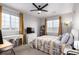 This bedroom features a ceiling fan, two windows with shades, a desk, and neutral-toned walls at 4451 S Ammons St # 5-307, Littleton, CO 80123