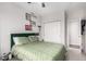 The bedroom has a ceiling fan, a double bed with green patterned bedding, and a closet at 4451 S Ammons St # 5-307, Littleton, CO 80123