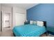 Cozy bedroom featuring blue accent wall, modern furniture, and natural light, creating a relaxing atmosphere at 4451 S Ammons St # 5-307, Littleton, CO 80123