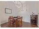 Dining room features a simple table and chairs set, along with a decorative wine rack and hardwood floors at 4451 S Ammons St # 5-307, Littleton, CO 80123