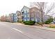 Modern blue apartment complex with well-maintained landscaping, sidewalks, and visible street parking. Unit number five is marked at 4451 S Ammons St # 5-307, Littleton, CO 80123