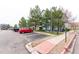 Exterior of apartment building showing parking spaces, sidewalk, and professional landscaping at 4451 S Ammons St # 5-307, Littleton, CO 80123