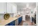 This kitchen features blue lower and white upper cabinets, stainless steel appliances, and wood-look floors at 4451 S Ammons St # 5-307, Littleton, CO 80123