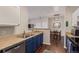 Kitchen view showcases the stainless sink, cabinets, and appliances, with a view into the adjacent dining area at 4451 S Ammons St # 5-307, Littleton, CO 80123