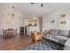 Cozy living room featuring hardwood floors, stylish furniture, and an open floor plan flowing to the kitchen at 4451 S Ammons St # 5-307, Littleton, CO 80123