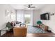 Cozy living room with hardwood floors, a gray sectional, a leather armchair and sliding doors that lead to a balcony at 4451 S Ammons St # 5-307, Littleton, CO 80123