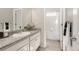 Bathroom featuring granite countertop, white cabinets, and access to a tiled shower/bath combo at 9080 W 100Th Way, Broomfield, CO 80021