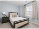 Cozy bedroom with a stylish bed, bedside table with lamp, and a window offering natural light at 9080 W 100Th Way, Broomfield, CO 80021