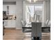 Elegant dining area featuring a modern table set and stylish pendant lighting and kitchen beyond at 9080 W 100Th Way, Broomfield, CO 80021