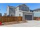 Beautiful two-story home with a modern gray exterior, a well-maintained lawn, and an attached garage at 9080 W 100Th Way, Broomfield, CO 80021