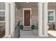 Close-up of the front door with stylish stone accents and elegant white columns and brickwork at 9080 W 100Th Way, Broomfield, CO 80021