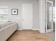 Hallway with hardwood floors with an entry door and doorway to the office at 9080 W 100Th Way, Broomfield, CO 80021