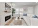 Modern living room features a fireplace, large white sectional, and bright, natural lighting at 9080 W 100Th Way, Broomfield, CO 80021