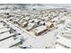 Winter aerial view showcases community homes with mountain backdrop and snow covered roofs at 19473 W 58Th Pl, Golden, CO 80403