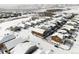 Winter aerial view showcasing community homes with tree lined roads and snow-covered roofs at 19473 W 58Th Pl, Golden, CO 80403