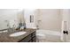 Bathroom featuring granite countertops and a tiled shower-tub combination at 19473 W 58Th Pl, Golden, CO 80403