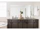 Bathroom featuring dual sinks, granite countertops, and modern fixtures at 19473 W 58Th Pl, Golden, CO 80403