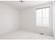 Bright bedroom featuring neutral carpet, a large window and fresh white walls at 19473 W 58Th Pl, Golden, CO 80403