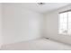 Bright bedroom featuring neutral carpet, a large window and fresh white walls at 19473 W 58Th Pl, Golden, CO 80403