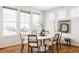 Bright dining area featuring a round white table with seating for six and large windows at 19473 W 58Th Pl, Golden, CO 80403