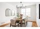 Dining area with a wood table, seating for six, stylish light fixture, and bright natural light at 19473 W 58Th Pl, Golden, CO 80403