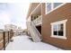 Two story exterior with stairs that lead to an upper-level outdoor patio at 19473 W 58Th Pl, Golden, CO 80403