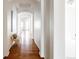 Bright hallway features hardwood floors, white walls, arched doorways, and bench seating at 19473 W 58Th Pl, Golden, CO 80403