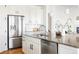 Modern kitchen with granite countertops, stainless steel refrigerator, and white cabinetry at 19473 W 58Th Pl, Golden, CO 80403