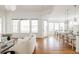 Open-concept living room with hardwood floors, lots of windows and a view into the dining area at 19473 W 58Th Pl, Golden, CO 80403