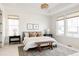 Bright main bedroom with large windows, a tray ceiling, and neutral decor at 19473 W 58Th Pl, Golden, CO 80403