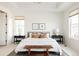 Bright main bedroom with large windows, a tray ceiling, and neutral decor at 19473 W 58Th Pl, Golden, CO 80403