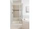 Elegant glass shower in a bathroom featuring neutral tiling and a built-in bench at 19473 W 58Th Pl, Golden, CO 80403