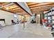 Spacious unfinished basement with exposed beam ceiling offers the opportunity for creative renovation and added living space at 11788 E Atlantic Pl, Aurora, CO 80014