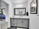 Bathroom featuring a vanity with white marble countertop, drawers, a framed mirror, and view into the shower at 11788 E Atlantic Pl, Aurora, CO 80014