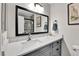 Bathroom vanity with a white countertop and a large mirror reflecting the shower at 11788 E Atlantic Pl, Aurora, CO 80014