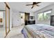 Bedroom with ceiling fan, neutral carpet, closet doors and view from the window at 11788 E Atlantic Pl, Aurora, CO 80014